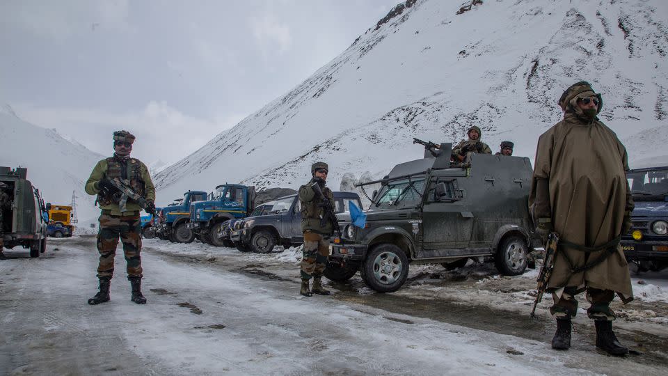 Indian soldiers stand guard along a highway in Ladakh in 2022. - Yawar Nazir/Getty Images