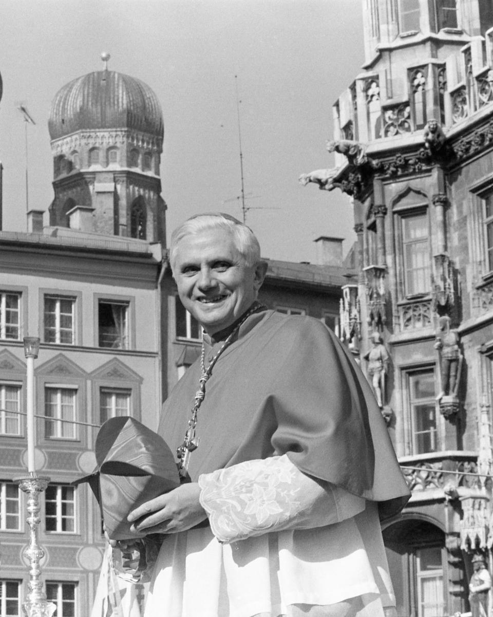 With the towers of Munich's cathedral in the background, Cardinal Joseph Ratzinger bids farewell to the Bavarian believers in downtown Munich, Germany on Sunday, Feb. 28, 1982. A service in the cathedral and a walk through the crowd marked the farewell of the cardinal who will head the Congregation of Faith in the Vatican. (AP Photo/Dieter Endlicher)
