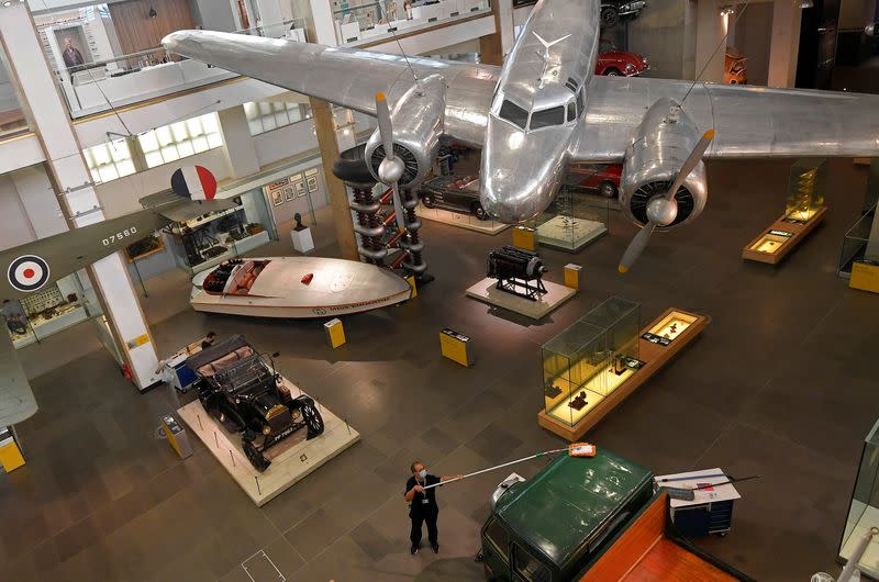 Employees clean exhibits ahead of the reopening of the Science Museum, in London, Britain