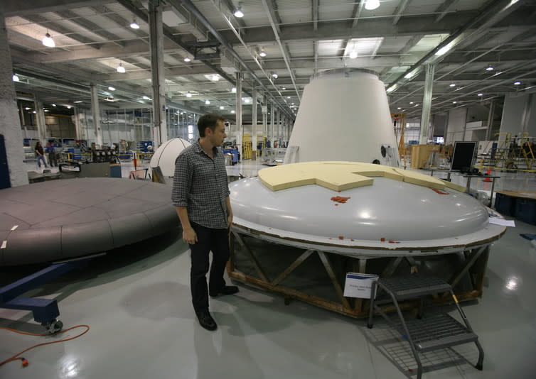 <span class="caption">Musk inspecting a heat shield at the SpaceX factory.</span> <span class="attribution"><span class="source">Steve Jurvetson/Flickr</span>, <a class="link " href="http://creativecommons.org/licenses/by/4.0/" rel="nofollow noopener" target="_blank" data-ylk="slk:CC BY;elm:context_link;itc:0;sec:content-canvas">CC BY</a></span>