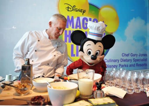 Mickey Mouse is seen at a display for healthy food during a press conference to announce changes to Disney's nutrition guideline policy at the Newseum in Washington