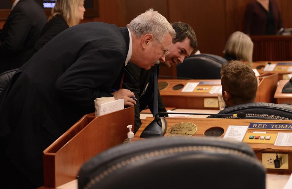 House Majority Leader Dan Saddler, R-Eagle River (left), and Rep. Will Stapp, R-Fairbanks, try to convince Rep. Jesse Sumner, R-Wasilla, to vote in favor of adjournment early Thursday, May 16, 2024. (Photo by James Brooks/Alaska Beacon)