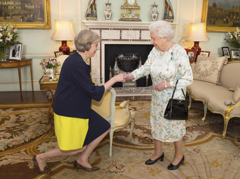FILE - Queen Elizabeth II welcomes Theresa May at the start of an audience in Buckingham Palace, London, where she invited the former Home Secretary to become Prime Minister and form a new government, on July 13, 2016. Former British Prime Minister Theresa May announced Friday, March 8, 2024, that she will quit as a lawmaker when an election is called this year, ending a 27-year parliamentary career that included three years as the nation’s leader during a period roiled by Brexit. (Dominic Lipinski/Pool, File via AP)
