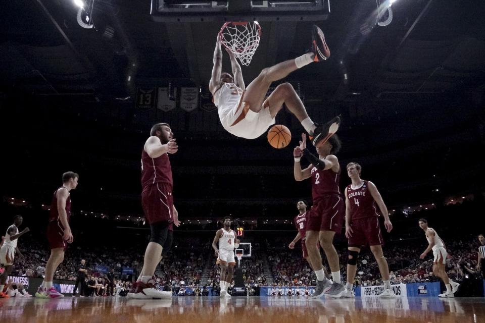 Texas' Christian Bishop dunks during second half of a first-round college basketball game against Colgate in the NCAA Tournament Thursday, March 16, 2023, in Des Moines, Iowa. (AP Photo/Charlie Neibergall)