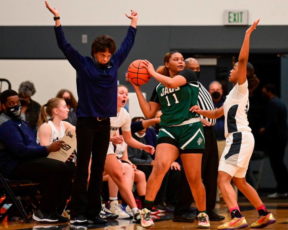 Bellarmine Prep head coach Cheryl Bishop encourages guard Kiara Stone (5) to keep her hands up to defend after Emerald Ridge guard Marecia Barnett (11) picked up her dribble along the sideline during the second quarter of a 4A South Puget Sound League game on Friday, Jan. 28, 2022, at Bellarmine Prep, in Tacoma, Wash.