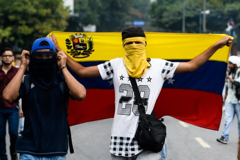 Venezuelan opposition activists clash with riot police in Caracas, on April 10, 2017