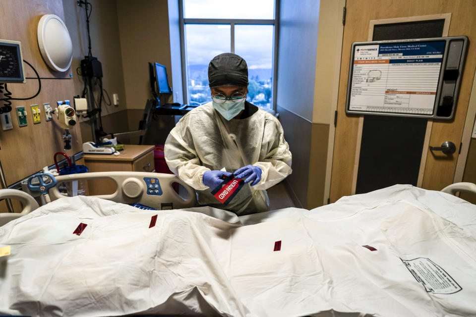 A registered nurse attaches a 