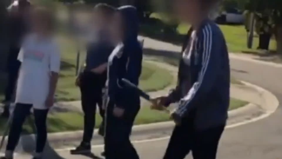 She was seen in the video waving a baseball bat, threatening her peers to take her on. Photo: 7News