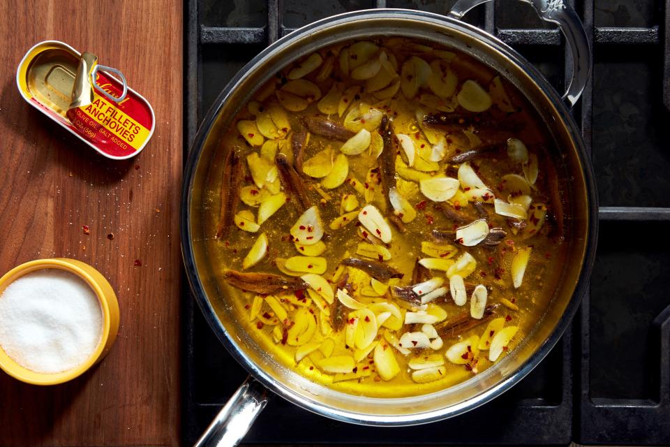 Why yes, there *is* a whole head of garlic and a whole tin of anchovies in this skillet!