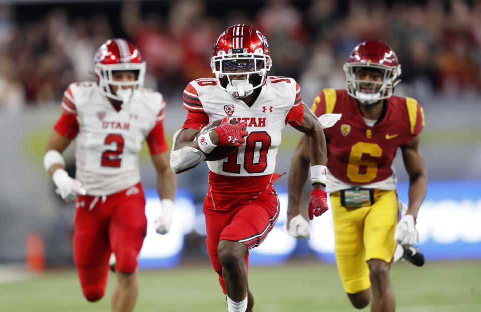 Utah wide receiver Money Parks (10) outruns Southern California defensive back Mekhi Blackmon (6) to score a touchdown during the second half of the Pac-12 Conference championship NCAA college football game Friday, Dec. 2, 2022, in Las Vegas. Utah running back Micah Bernard is at left. (AP Photo/Steve Marcus)