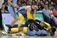 Memphis Grizzlies forward Dillon Brooks, standing, guard Ja Morant (12), and Los Angeles Clippers forward Robert Covington, center, struggle for control of the ball in the second half of an NBA basketball game Wednesday, March 29, 2023, in Memphis, Tenn. (AP Photo/Brandon Dill)