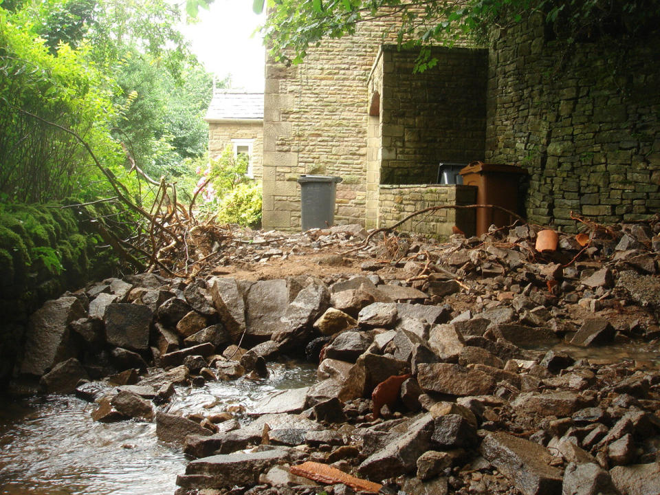 A collapsed road in Fernilee Hamlet, just outside Whaley Bridge, Derbyshire, where people have been evacuated amid fears of a reservoir dam collapse (Picture: SWNS) 