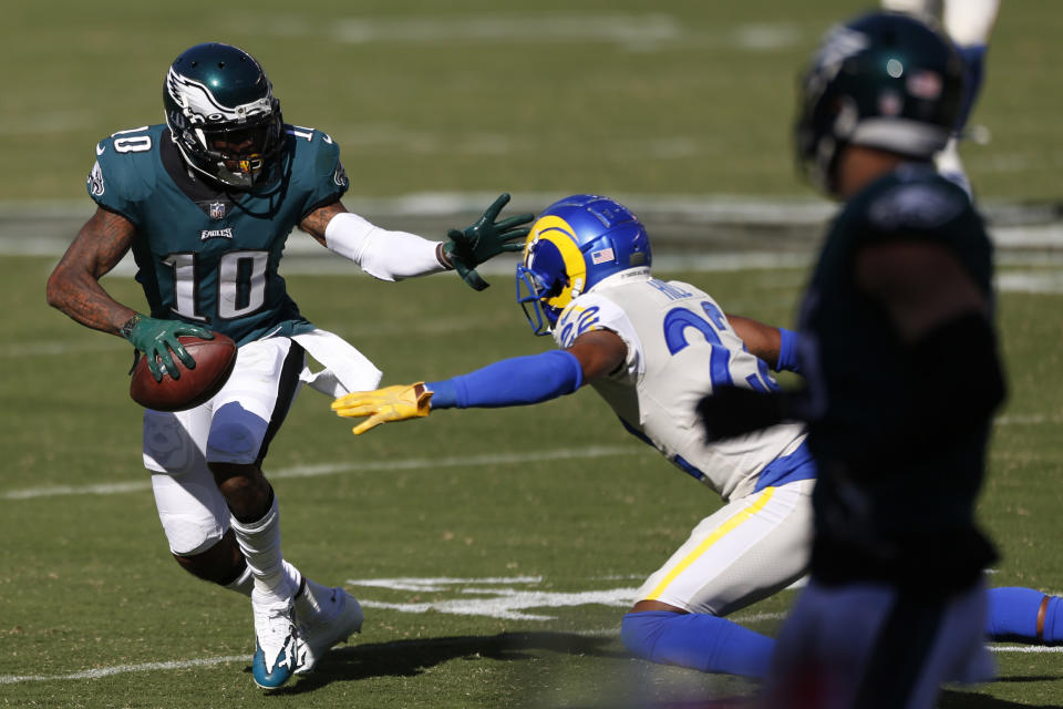 Philadelphia Eagles' DeSean Jackson, left, tries to slip past Los Angeles Rams' Troy Hill during the second half of an NFL football game, Sunday, Sept. 20, 2020, in Philadelphia. (AP Photo/Laurence Kesterson)