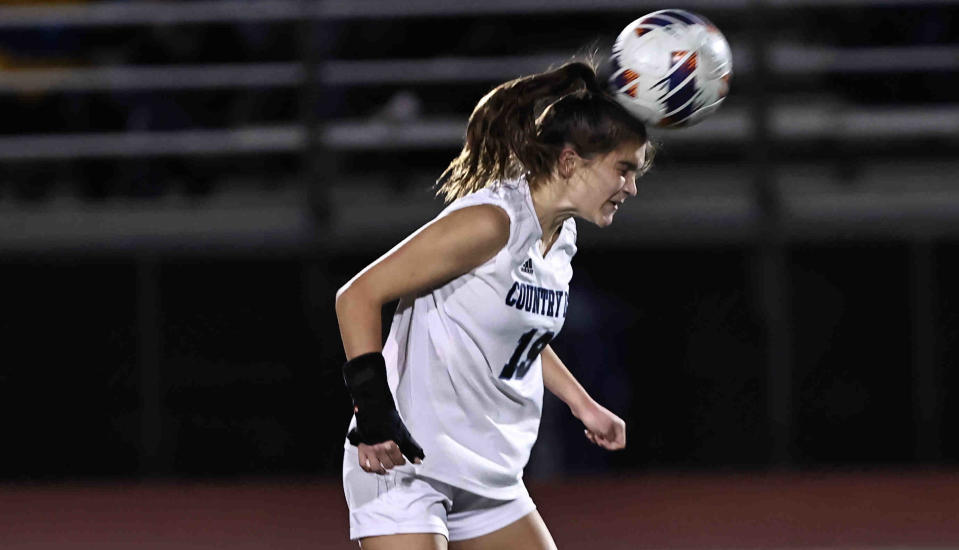 Cincinnati Country Day player Sydney Hardesty (19) heads the ball during their tournament game against Lynchburg-Clay Tuesday, Nov. 8, 2022.