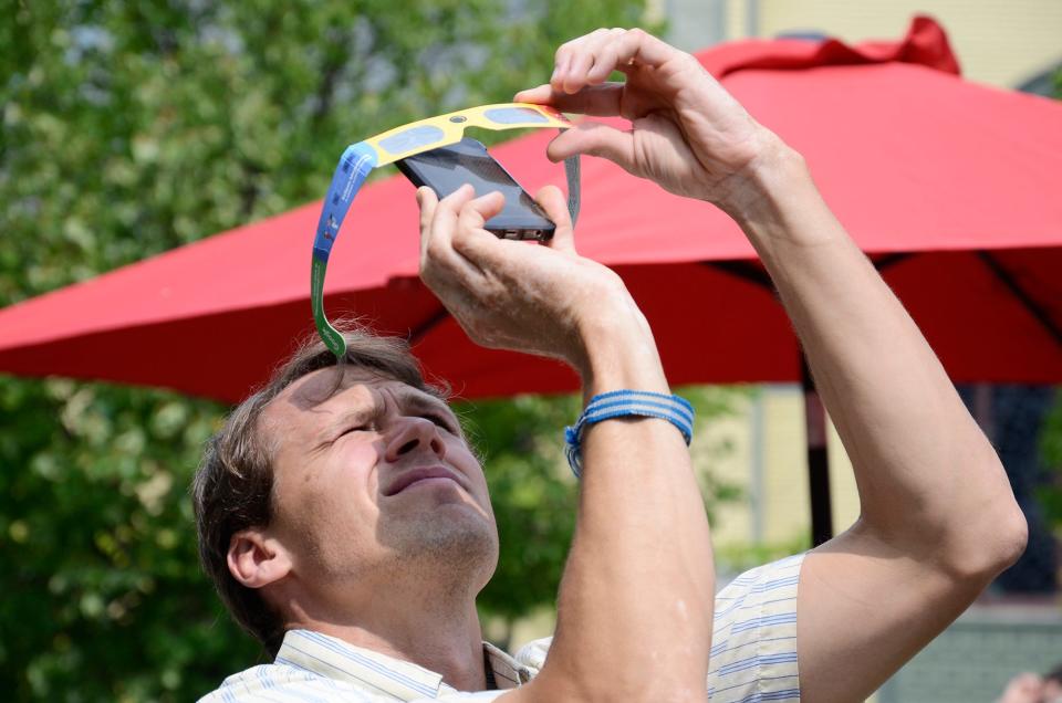 Mark Drinkall gets creative while trying to take photos of the 2017 solar eclipse at the Petoskey District Library.