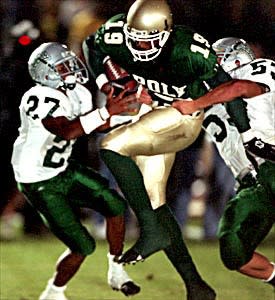 Long Beach Poly's Marcedes Lewis tries to get past Concord De La Salle defenders Alijah Bradley (left) and Cole Smith.