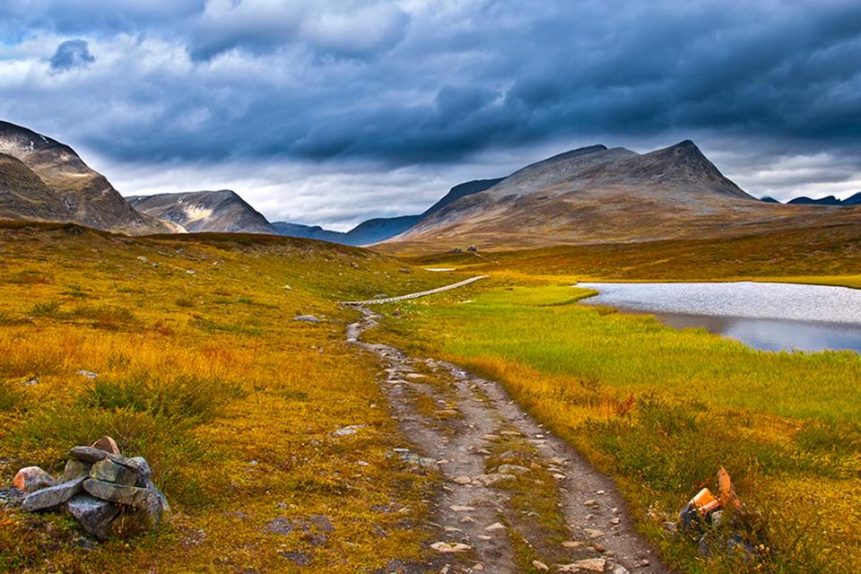 Path leading through empty countryside and mountains