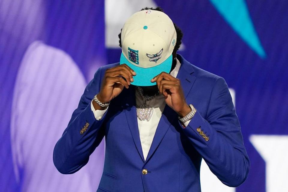Mark Williams, right, dons a Charlotte Hornets cap after being selected 15th overall by the Charlotte Hornets in the NBA basketball draft, Thursday, June 23, 2022, in New York. (AP Photo/John Minchillo)