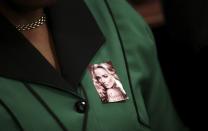 A member of the ANCWL (African National Congress Women's League) wears a picture of late Reeva Steenkamp as she attends Olympic and Paralympic track star Oscar Pistorius murder trial at the North Gauteng High Court in Pretoria, March 5, 2014. Pistorius is on trial for murdering his girlfriend Reeva Steenkamp at his suburban Pretoria home on Valentine's Day last year. He says he mistook her for an intruder. REUTERS/Siphiwe Sibeko (SOUTH AFRICA - Tags: SPORT ATHLETICS CRIME LAW)