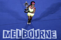 FILE - Serena Williams of the U.S. holds the trophy after defeating Maria Sharapova of Russia in the women's singles final at the Australian Open tennis championship in Melbourne, Australia, Saturday, Jan. 31, 2015. Saying “the countdown has begun,” 23-time Grand Slam champion Serena Williams announced Tuesday, Aug. 9, 2022, she is ready to step away from tennis so she can turn her focus to having another child and her business interests, presaging the end of a career that transcended sports. (AP Photo/Lee Jin-man, File)