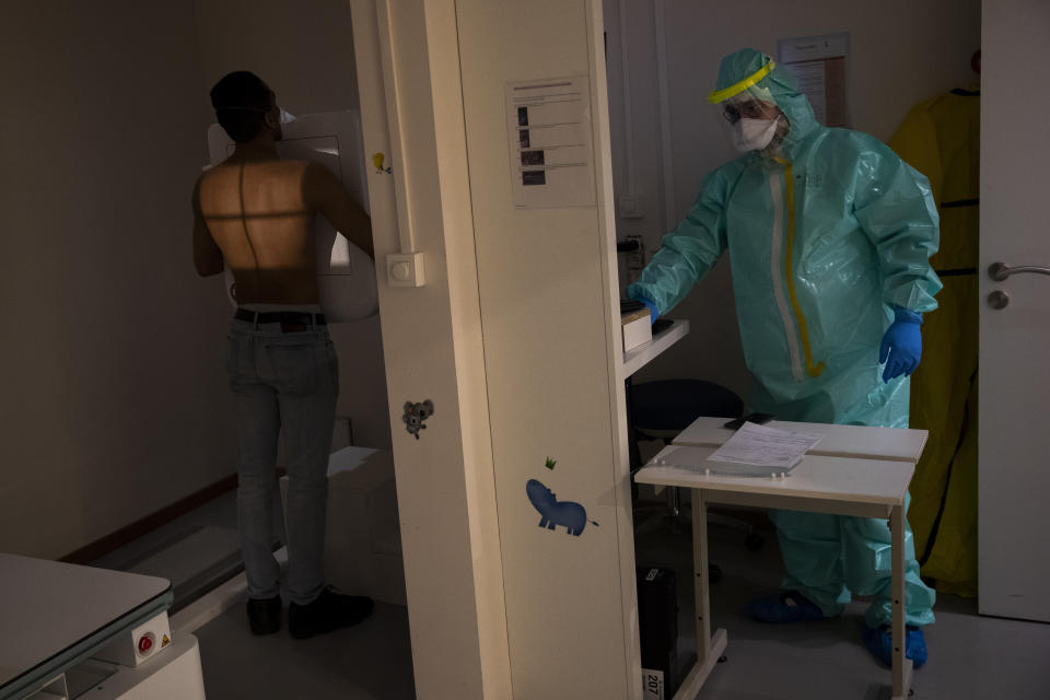 Medical staffer Wassim Kamari, who has symptoms of coronavirus, receives an x-ray of his lungs at the polyclinic Klinicare during a partial lockdown against the spread of Covid-19 in Brussels, Monday, April 6, 2020. The new coronavirus causes mild or moderate symptoms for most people, but for some, especially older adults and people with existing health problems, it can cause more severe illness or death. (AP Photo/Francisco Seco)