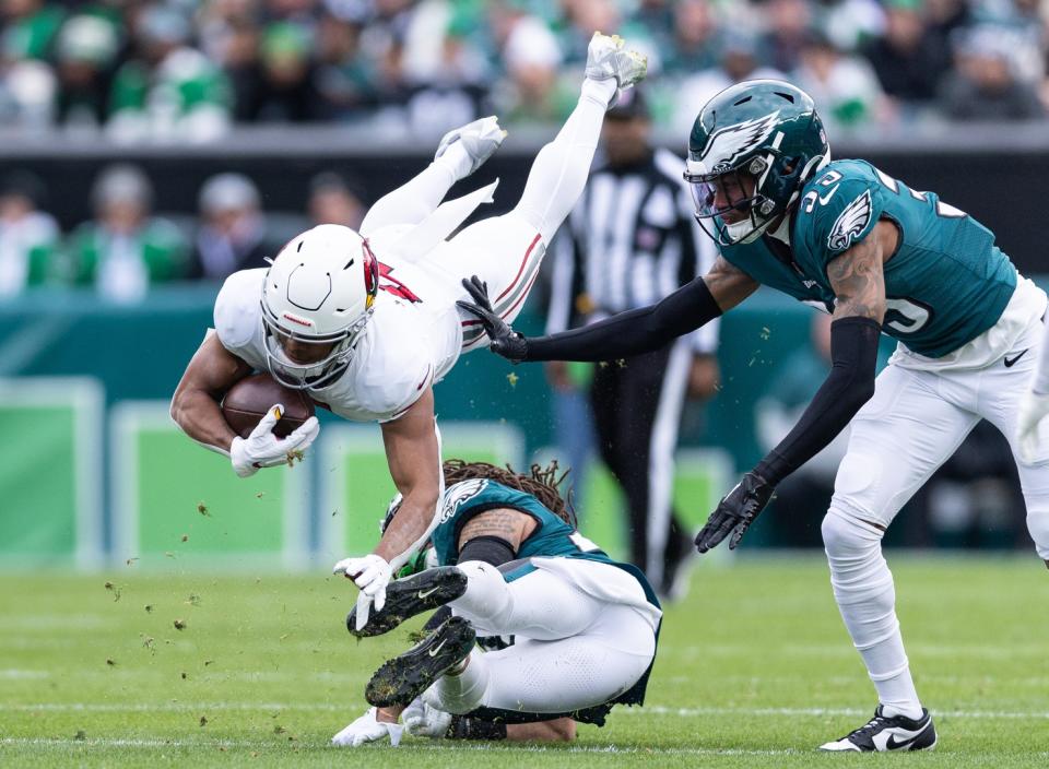 Dec 31, 2023; Philadelphia, Pennsylvania, USA; Arizona Cardinals wide receiver Rondale Moore (4) is tackled by Philadelphia Eagles cornerback Avonte Maddox (29) in front of cornerback Eli Ricks (39) during the second quarter at Lincoln Financial Field. Mandatory Credit: Bill Streicher-USA TODAY Sports