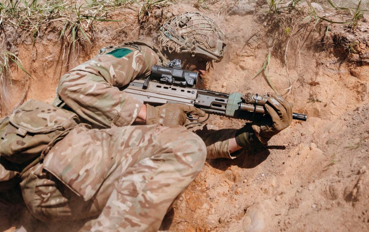 A British soldier comes under simulated enemy fire in the Nato exercise in Estonia