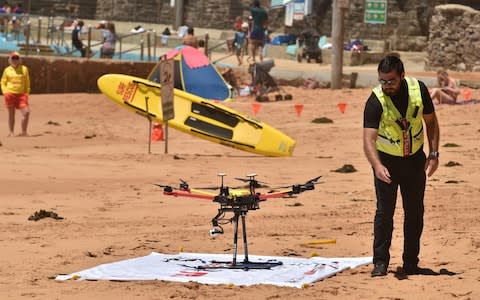  Drone pilot Ben Trollope checking his shark-spotting drone on Bilgola beach north of Sydney. - Credit:  AFP