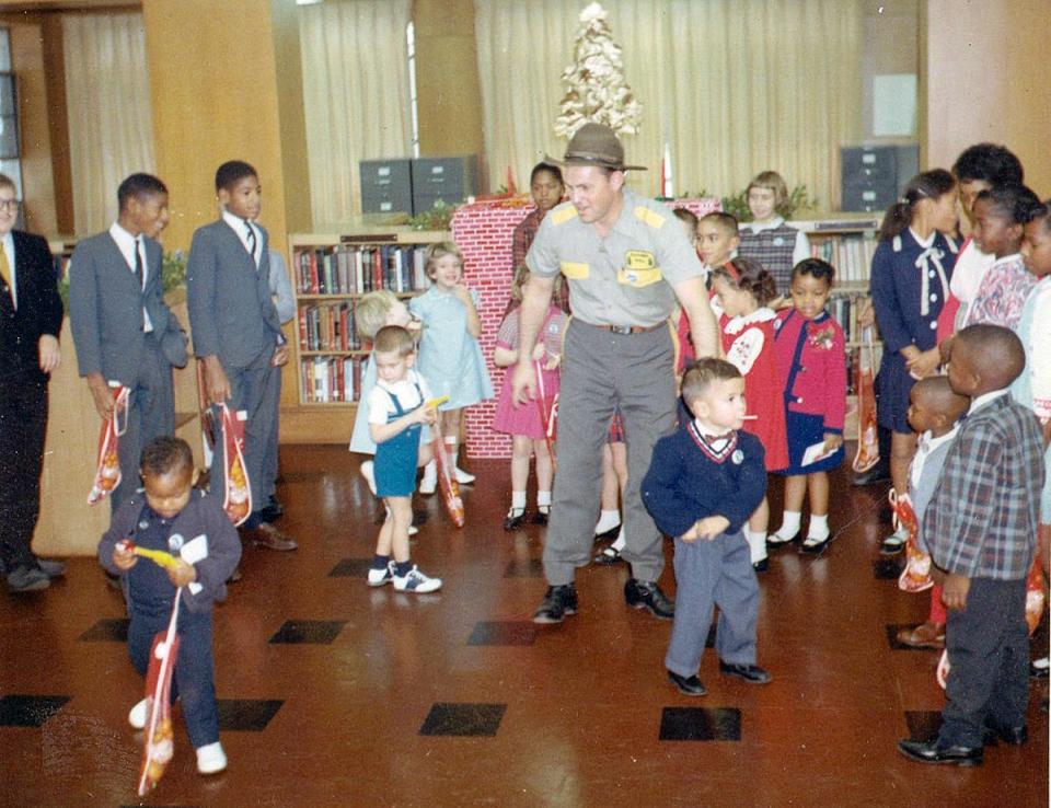 Henry Baranek, who played Ranger Hal on WJXT from 1958 to 1969, meets with children at the library during a Christmas party in 1965.