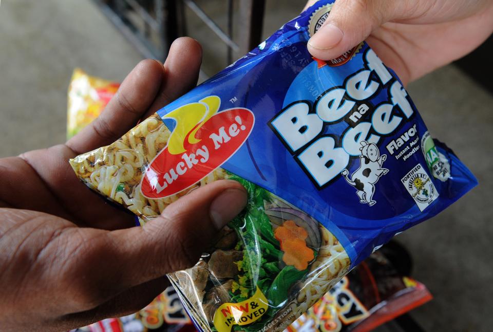 FILE PHOTO: This photo illustration shows a man buying instant noodles made by local instant noodle firm Monde Nissin at a village convenience store in suburban Manila on October 11, 2015.  (Photo: JAY DIRECTO/AFP via Getty Images)