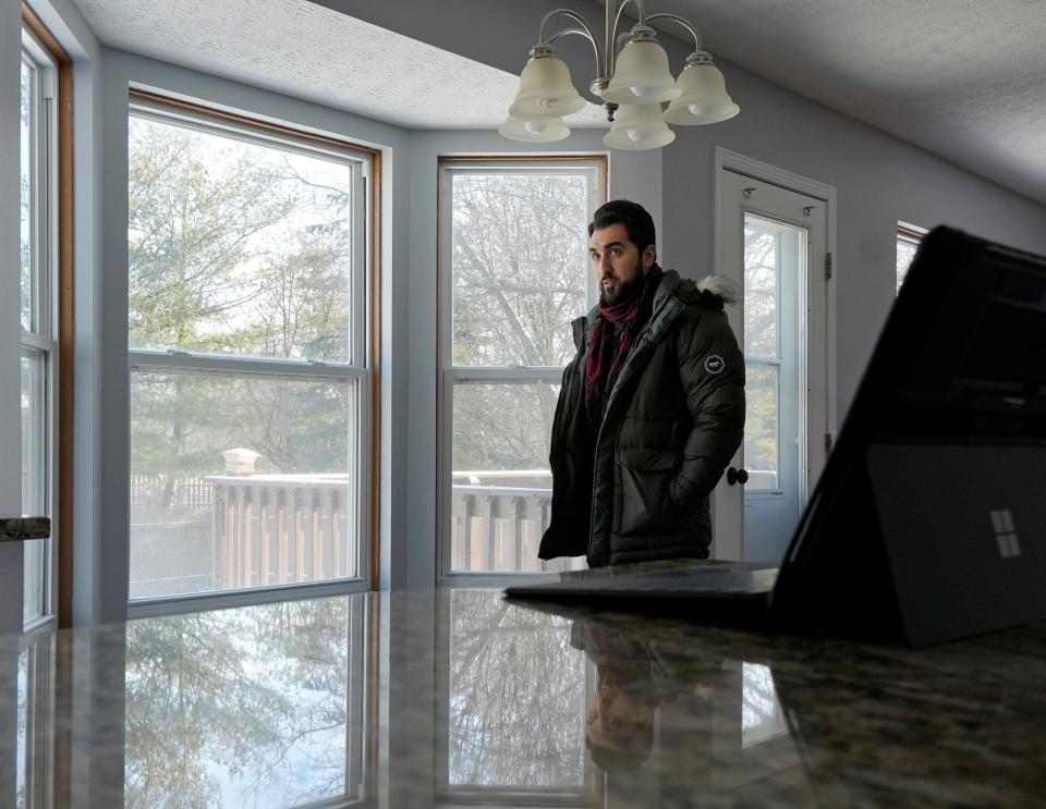 Sinan Falah, an Iraq refugee and real estate agent, waits to show a home to potential buyers on Sunday, Jan. 14, 2024, in Lewis Center, Delaware County.