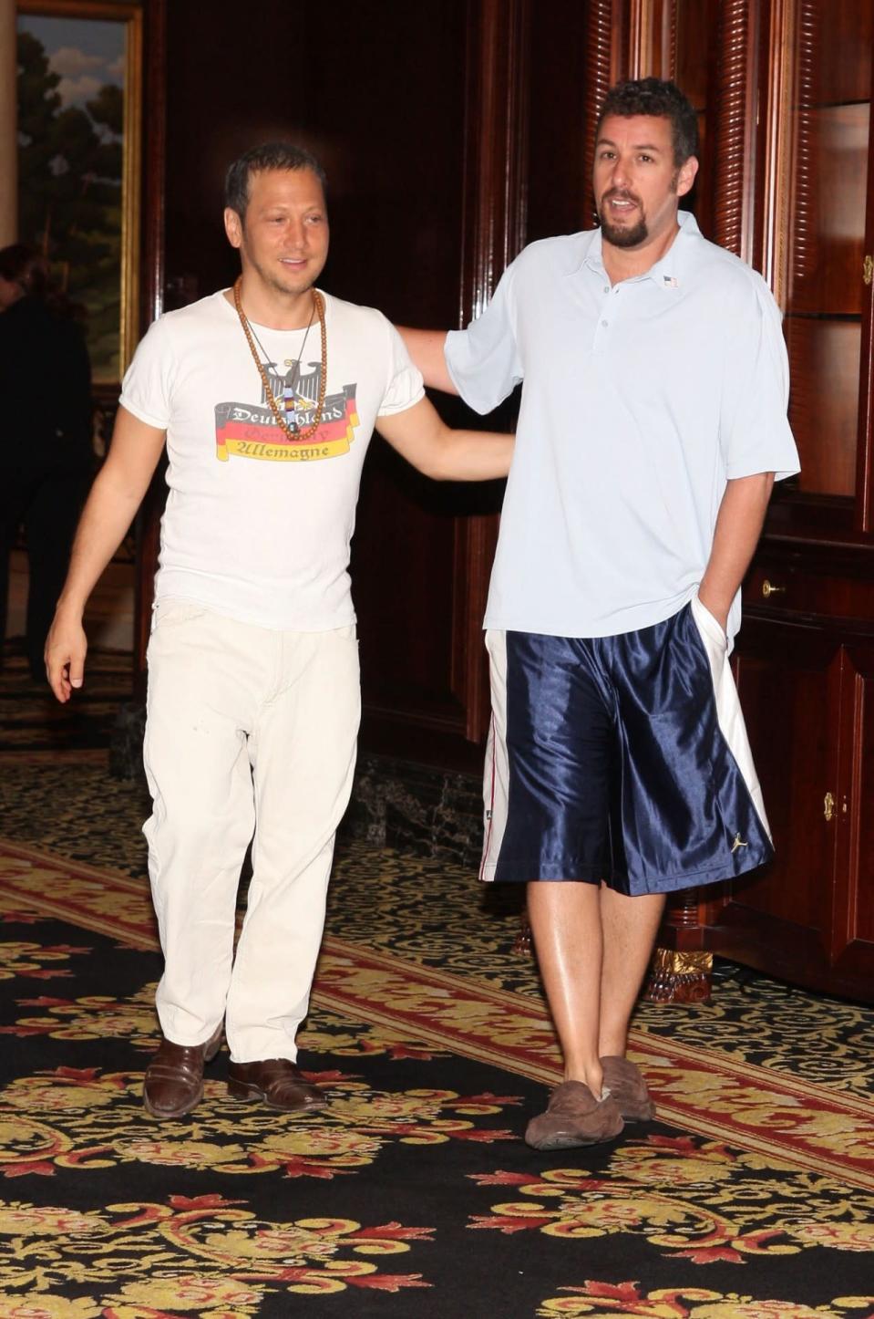 <p>Even when Sandler’s abroad, he’s all about being comfy. He was spotted with his longtime buddy Rob Schneider at the Berlin premiere of <i>You Don’t Mess With the Zohan</i> in 2008, wearing his favorite slippers. (Photo: Anita Bugge/WireImage)</p>