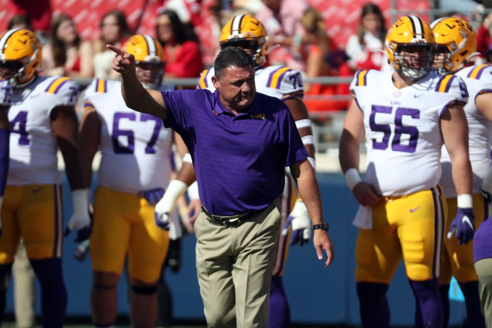 Oct 23, 2021; Oxford, Mississippi, USA; LSU Tigers head coach Ed Orgeron leads his team onto the field prior to their game against the Mississippi Rebels at Vaught-Hemingway Stadium. Mandatory Credit: Petre Thomas-USA TODAY Sports