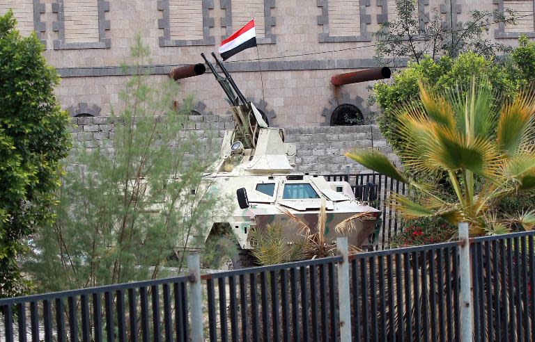 An armoured vehicle mounted with anti-aircraft guns is stationed near the defence ministry in Sanaa on March 26, 2015, as tribal gunmen gather to protest against the Saudi-led intervention