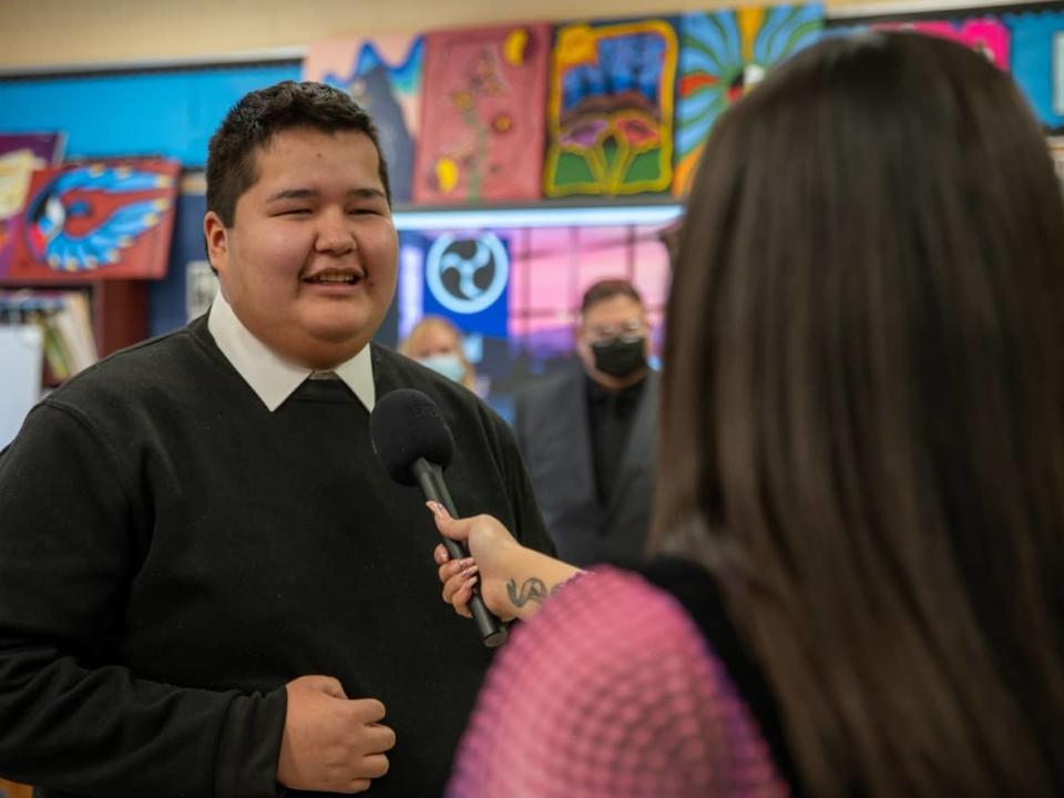 Dennis Franklin Cromarty student Chief Derek Monias is interviewed by CBC's Jasmine Kabatay after wrapping up his interview with Ryan Reynolds.  (Joaquin Powassin/CBC - image credit)