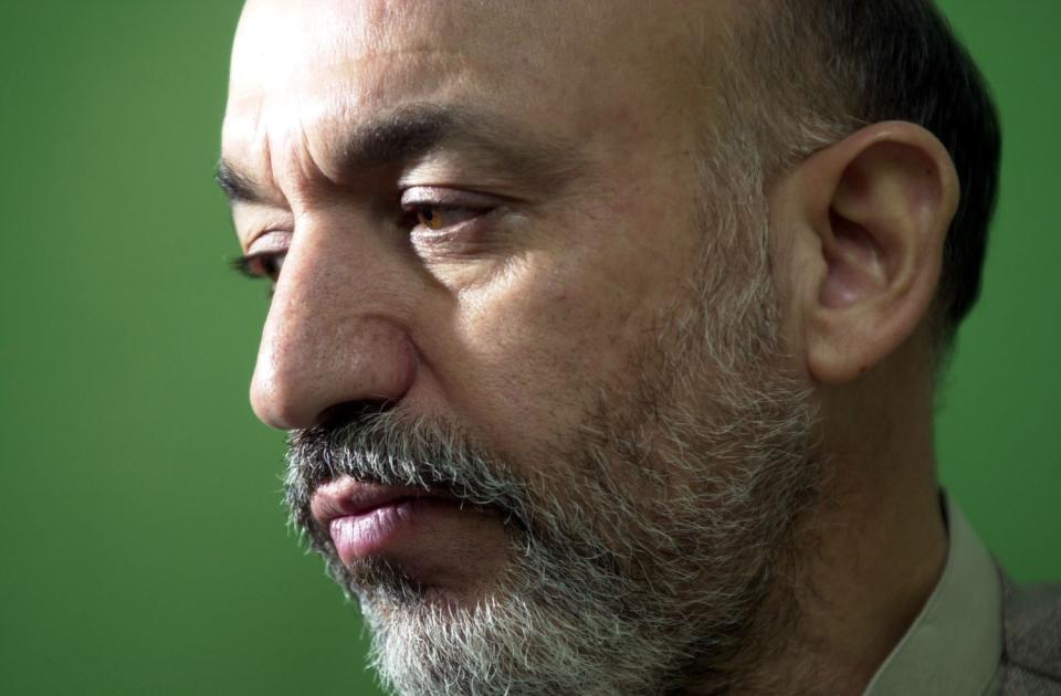 Hamid Karzai, center, sits with his supporters at home on Oct. 6, 2001, in, Quetta, Pakistan.