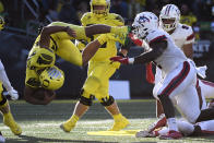 Oregon running back Travis Dye (26) is upended during a run in the second quarter of an NCAA college football game against Stony Brook Saturday, Sept. 18, 2021, in Eugene, Ore. (AP Photo/Andy Nelson)