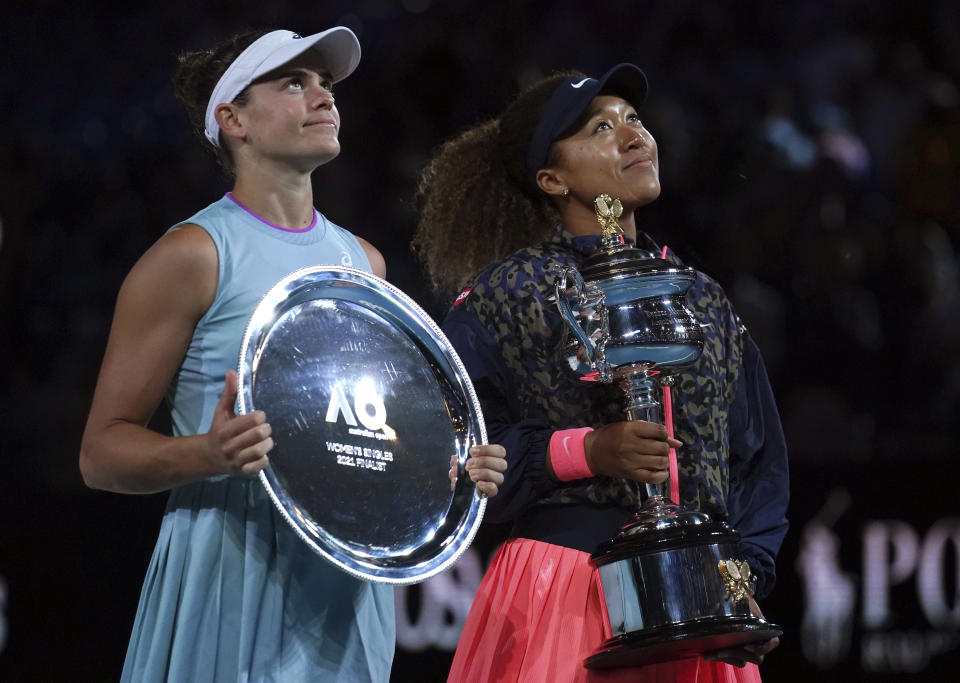 Japan's Naomi Osaka, right, holds the Daphne Akhurst Memorial Cup after defeating United States Jennifer Brady, left, in the women's singles final at the Australian Open tennis championship in Melbourne, Australia, Saturday, Feb. 20, 2021.(AP Photo/Mark Dadswell)