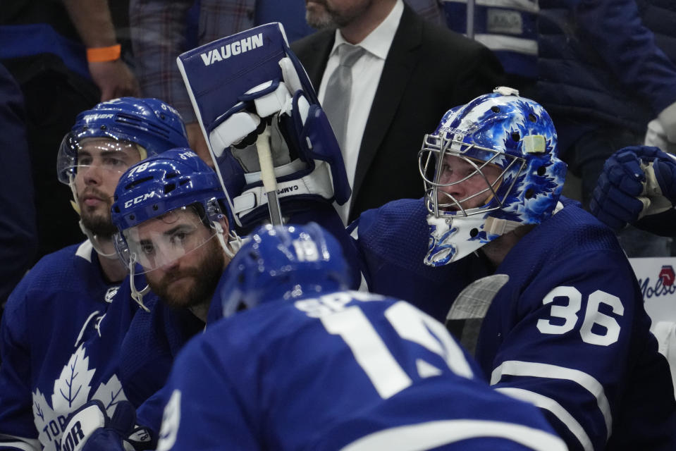 Toronto Maple Leafs goaltender Jack Campbell (36) and teammates TJ Brodie, center, and Justin Holl, left, react after Game 7 of an NHL hockey first-round playoff series against hte Tampa Bay Lightning in Toronto, Saturday, May 14, 2022. (Frank Gunn/The Canadian Press via AP)