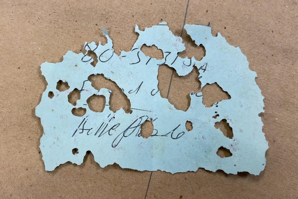 What's left of the paper found with the boxes of remains marked "1928 Hurricane Victims."