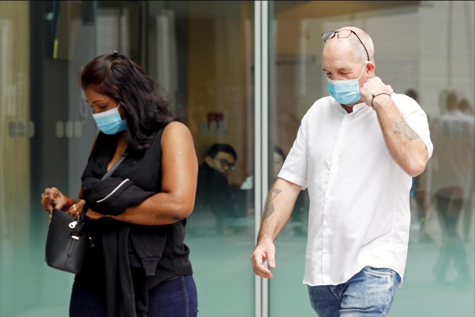 <p>Briton Skea Nigel and partner Agatha Maghesh Eyamalai arrive at the State Courts</p> (REUTERS)