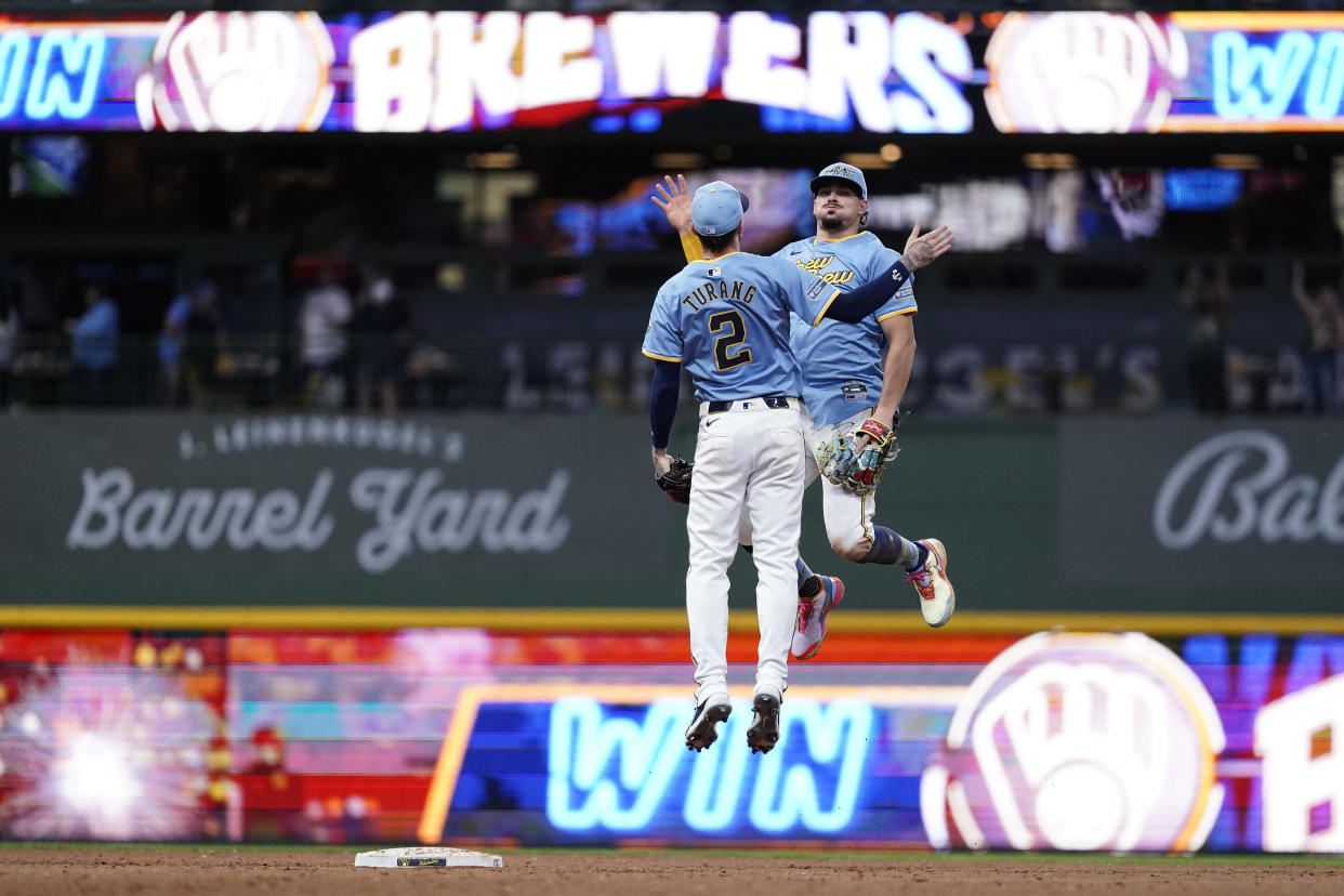 Milwaukee Brewers' Willy Adames and Brice Turang (2) jump in unison together after a baseball game against the Arizona Diamondbacks, Sunday, Sept. 22, 2024, in Milwaukee. (AP Photo/Aaron Gash)