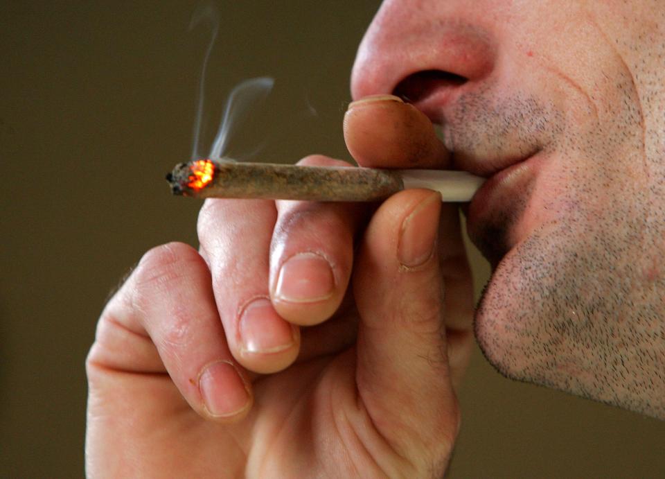 FILE - A man smokes a cannabis joint of  in a cafe on February 7, 2007.