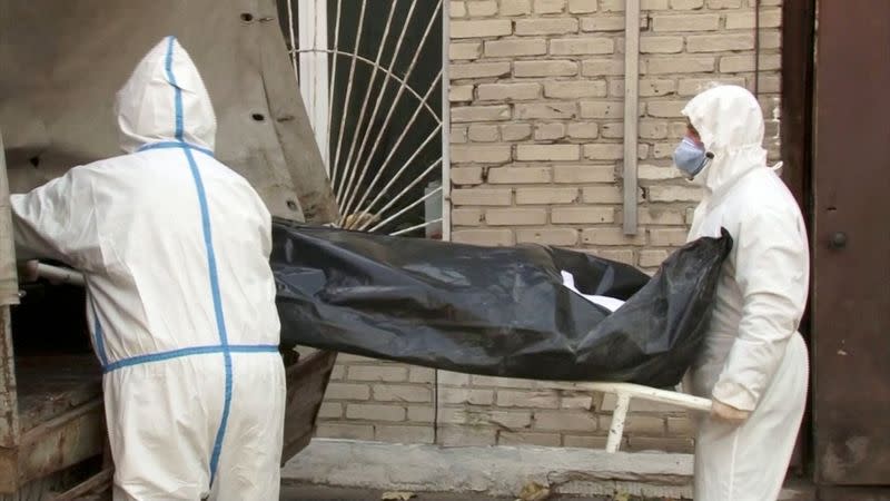 Medical specialists carry a stretcher outside a hospital morgue amid the outbreak of the coronavirus disease (COVID-19) in Barnaul