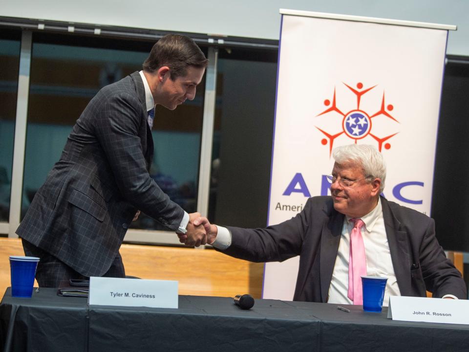 Knoxville municipal judge candidates Tyler Caviness, left, and John Rosson Jr. shake hands after answering questions during a forum hosted by the League of Women Voters of Knoxville-Knox County at Messiah Fellowship Church on Oct. 9 in Knoxville.