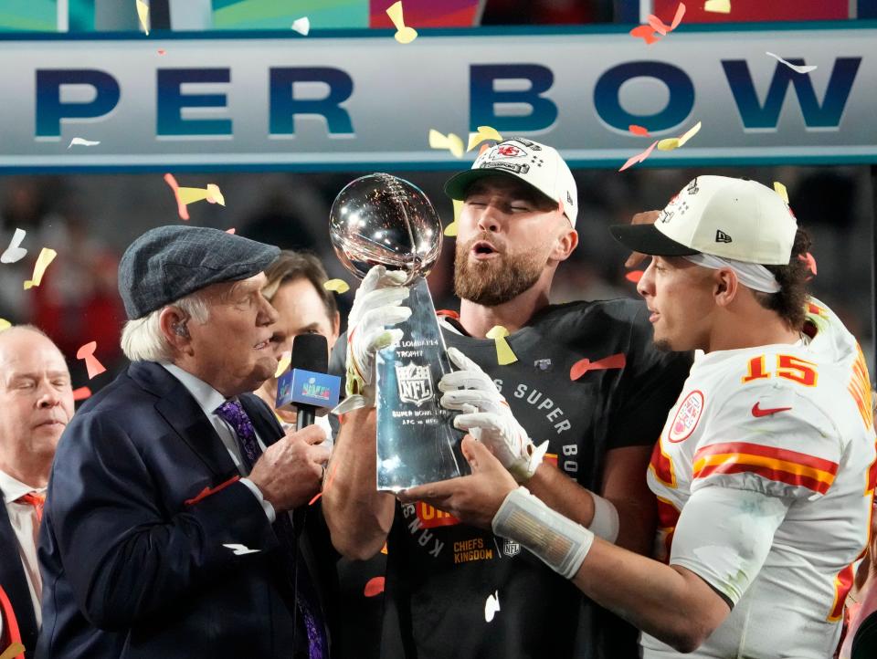 Kansas City Chiefs quarterback Patrick Mahomes passes the the Lombardi Trophy to tight end Travis Kelce after defeating the Philadelphia Eagles in the Super Bowl. The teammates are investing in Chicken N Pickle, a pickleball and restaurant chain, that will open in Kansas City.