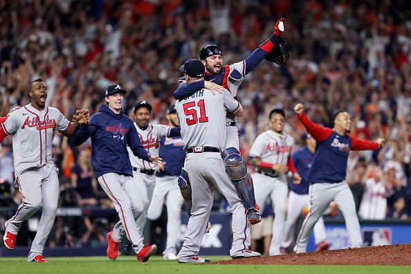 HOUSTON, TEXAS - NOVEMBER 02:  Will Smith #51 and Travis d'Arnaud #16 of the Atlanta Braves celebrate the team's 7-0 victory against the Houston Astros in Game Six to win the 2021 World Series at Minute Maid Park on November 02, 2021 in Houston, Texas. (Photo by Elsa/Getty Images)