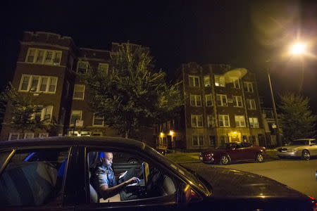 A Cook County Sheriff police officer does a computer check of a person's identification during a traffic stop in the Austin neighborhood in Chicago, Illinois, United States, September 9, 2015. REUTERS/Jim Young