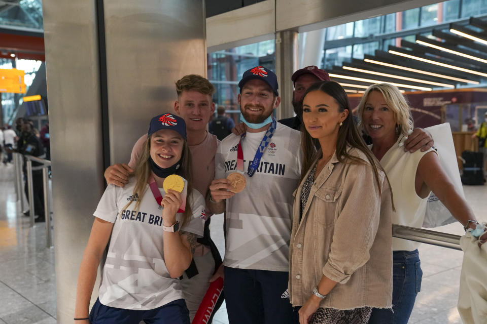 Charlotte Worthington (left) who won gold in the BMX Freestyle and Declan Brooks (centre) who won bronze arrive back at London Heathrow Airport from the Tokyo 2020 Olympic Games. Picture date: Tuesday August 3, 2021.