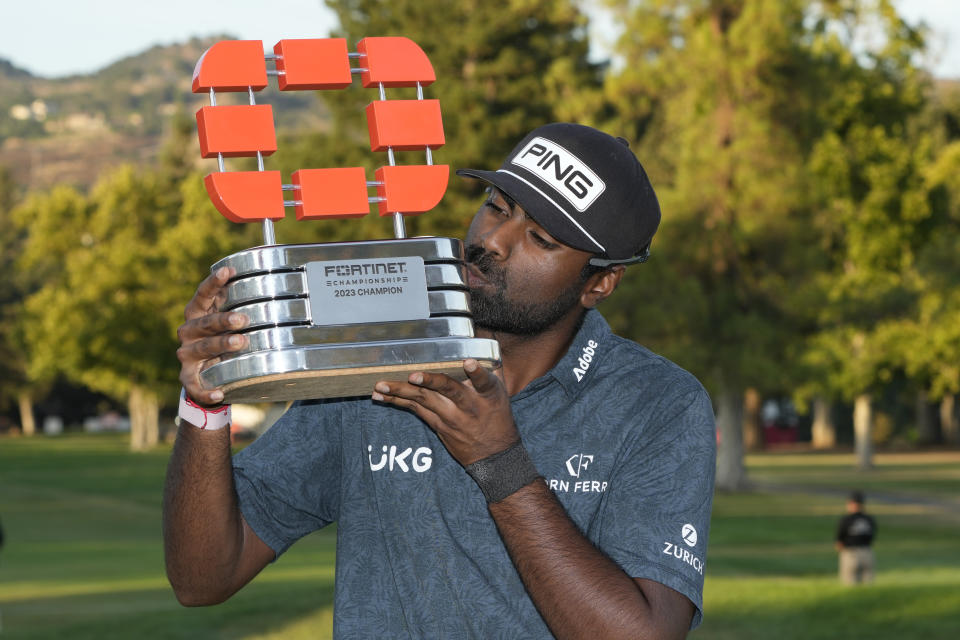 Sahith Theegala kisses his trophy on the 18th green of the Silverado Resort North Course after winning the Fortinet Championship PGA golf tournament in Napa, Calif., Sunday, Sept. 17, 2023. (AP Photo/Eric Risberg)